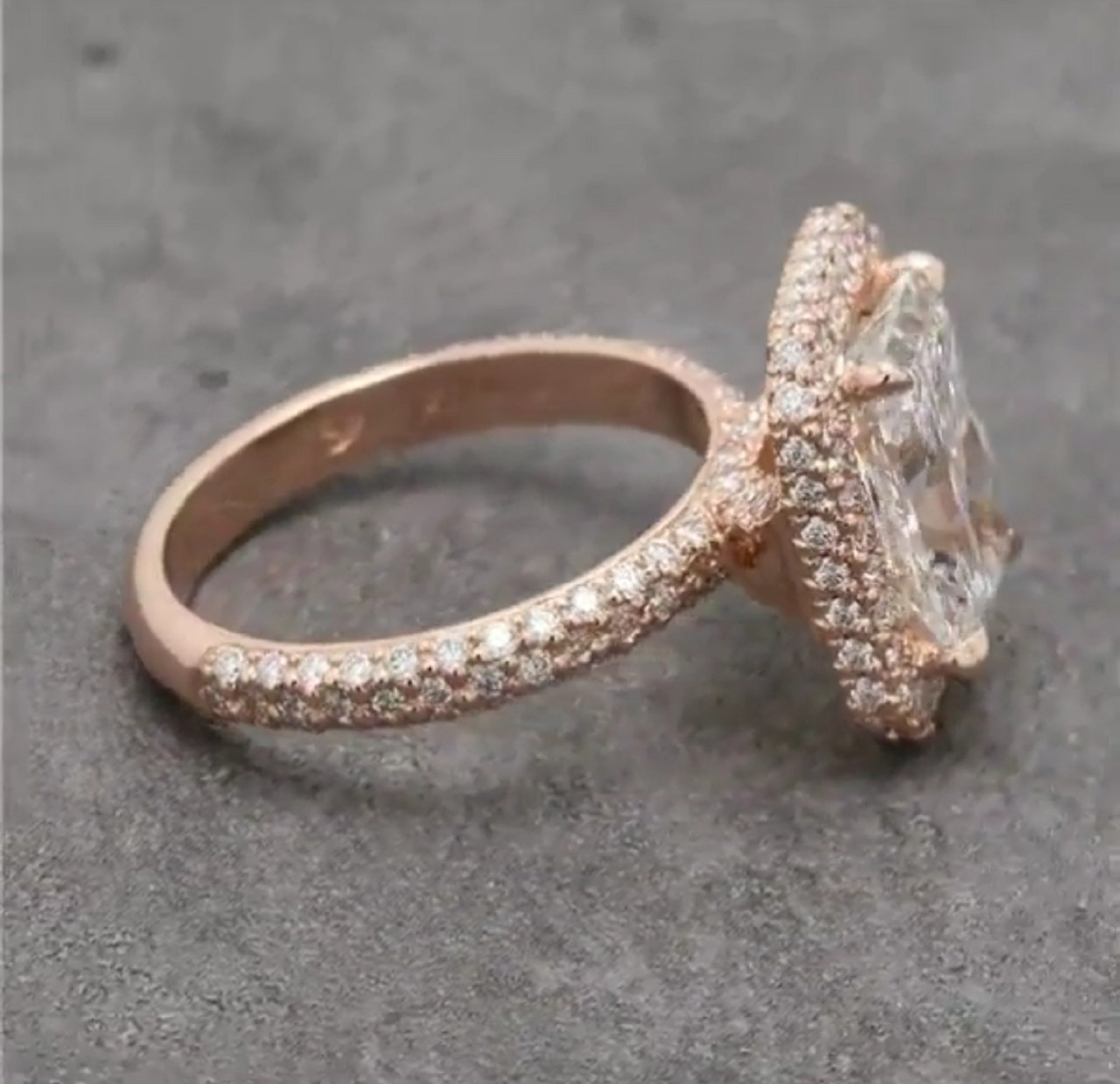 Side angle view showing the elevated radiant halo setting and continuous diamond sparkle along the band.