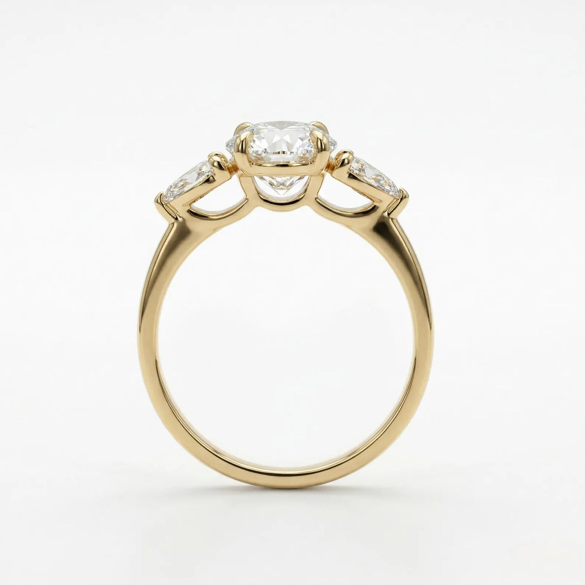 Side profile view of a yellow gold three stone ring showing the basket setting under a 4 ct oval lab grown diamond.