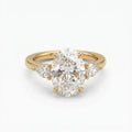Top-down front view of a 4 CT oval cut lab grown diamond engagement ring flanked by brilliant pear side diamonds in yellow gold.