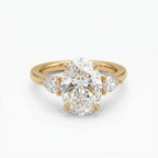 Top-down front view of a 4 CT oval cut lab grown diamond engagement ring flanked by brilliant pear side diamonds in yellow gold.