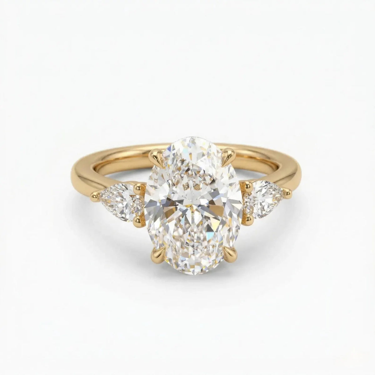 Top-down front view of a 4 CT oval cut lab grown diamond engagement ring flanked by brilliant pear side diamonds in yellow gold.