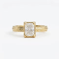 Front face-up view of a 3 carat radiant cut lab grown diamond engagement ring with a 14K yellow gold grooved band.