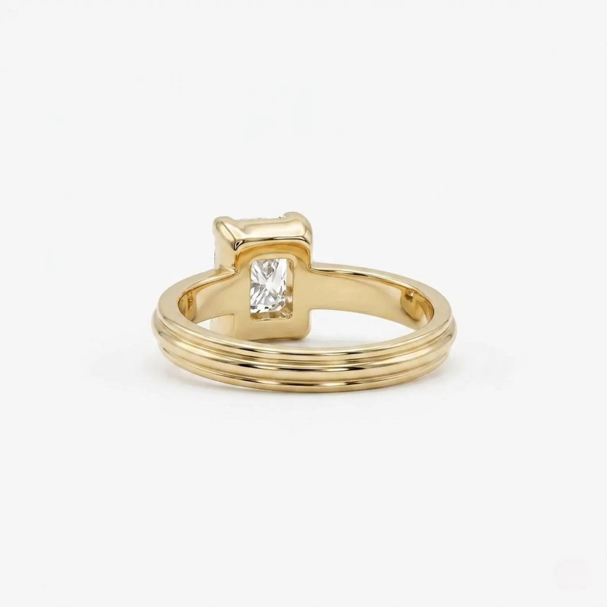 Rear perspective view showing the interior band design and open basket gallery under a 3 CT radiant cut lab diamond.