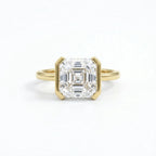Face-up view showing the step-cut facets of a 3 carat Asscher cut lab grown diamond in yellow gold.
