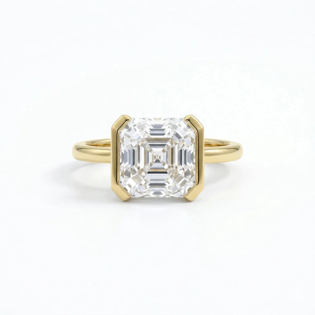 Face-up view showing the step-cut facets of a 3 carat Asscher cut lab grown diamond in yellow gold.