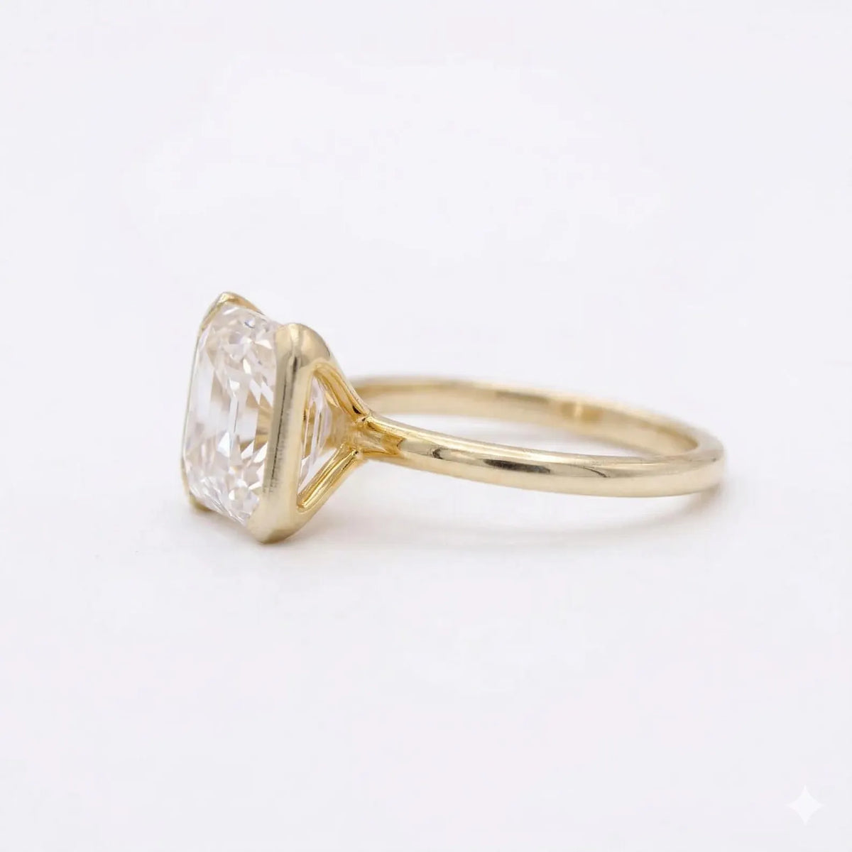 Side profile view of a 3 CT Asscher cut lab grown diamond engagement ring with open cathedral gallery.
