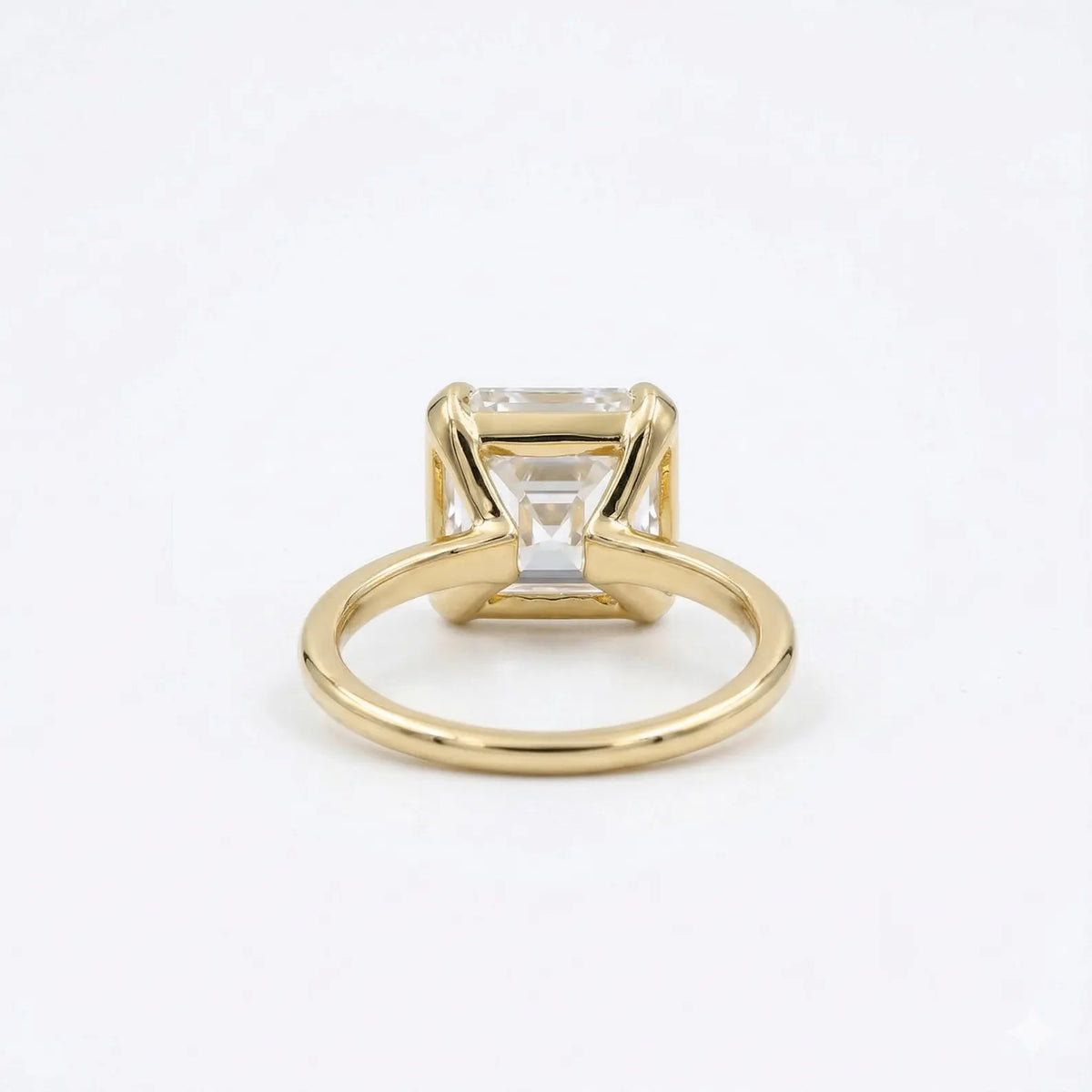 Undergallery view showing the secure corner bezel setting and slim band of a 3ct Asscher diamond ring.