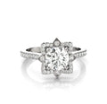 Front view of a 3 CT round cut lab grown diamond engagement ring with a star halo setting and pave band in white gold.