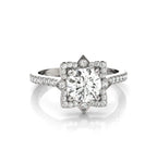Front view of a 3 CT round cut lab grown diamond engagement ring with a star halo setting and pave band in white gold.
