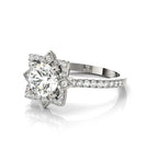 Perspective angle showing the brilliant round center diamond and diamond-accented band of a white gold halo ring.