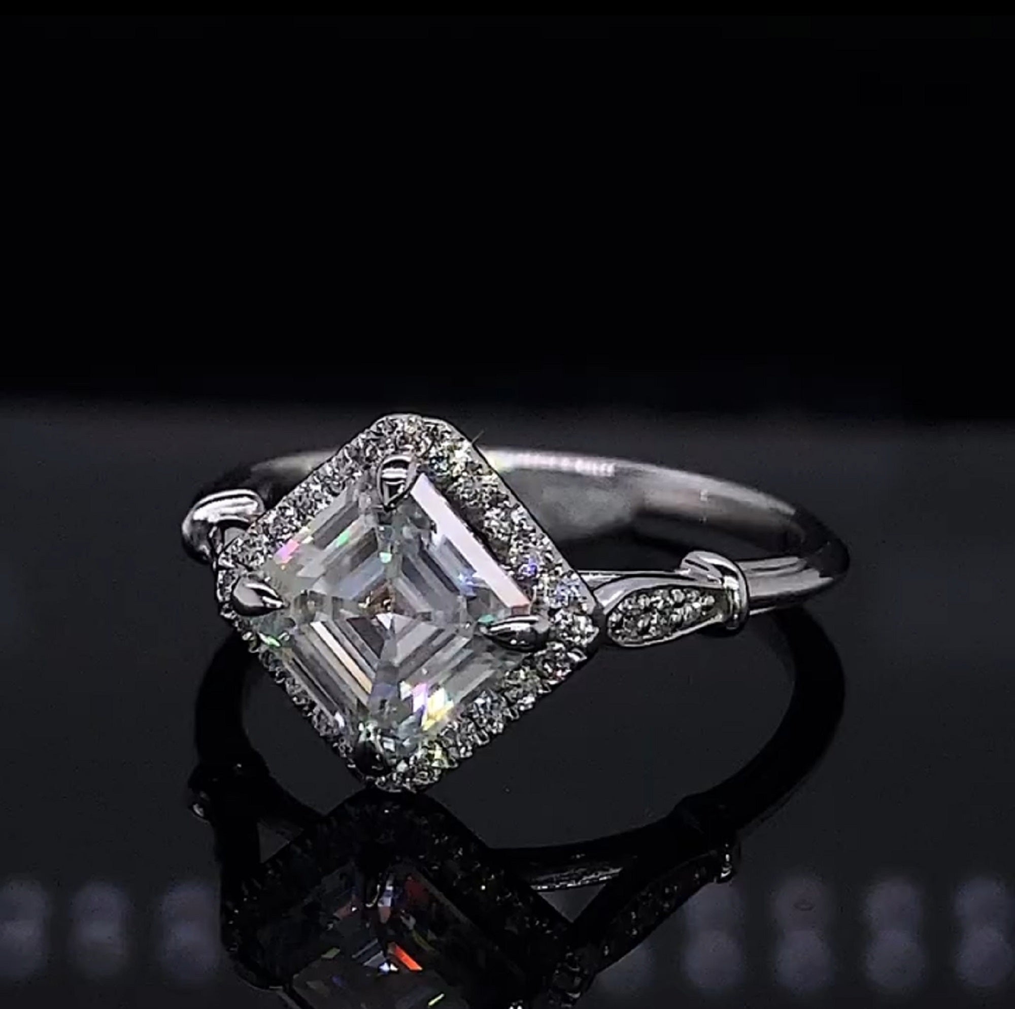 Direct top view showing the step-cut facets and compass-set orientation of a 2 carat Asscher lab diamond in a micro-pavé halo.