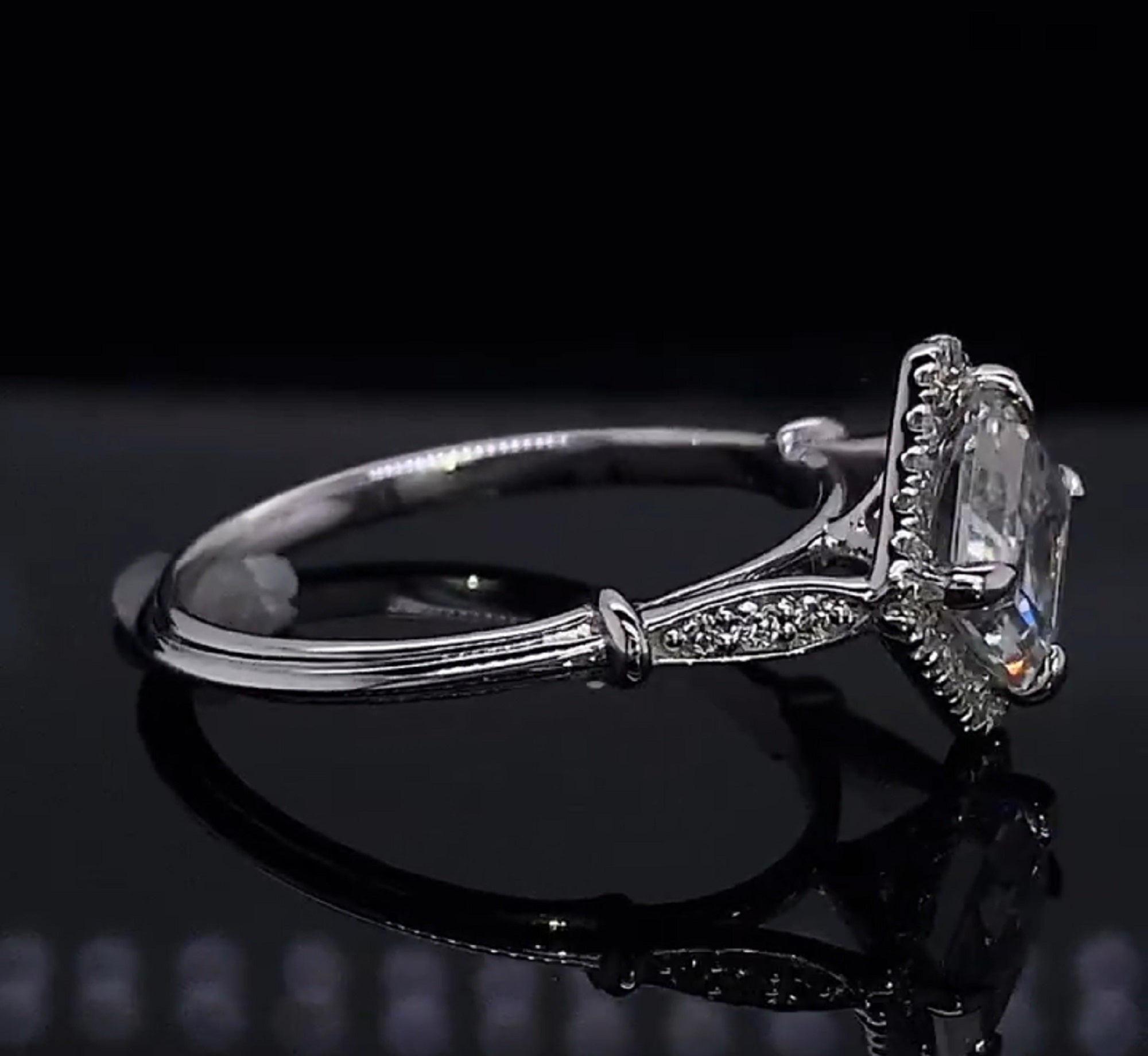 Side-angle shot displaying the vintage-inspired shoulder collar detail and micro-pavé accent diamonds on the white gold band.