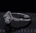 Side-angle shot displaying the vintage-inspired shoulder collar detail and micro-pavé accent diamonds on the white gold band.