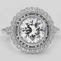 Top-down close-up view of a brilliant 3 CT round lab grown diamond surrounded by a milgrain bezel and halo of micro-pave diamonds.