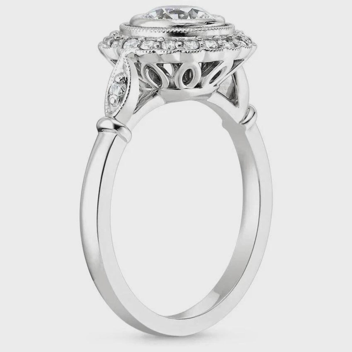 Side profile of a vintage lab grown diamond engagement ring displaying the openwork filigree under-gallery and diamond accent shoulders.