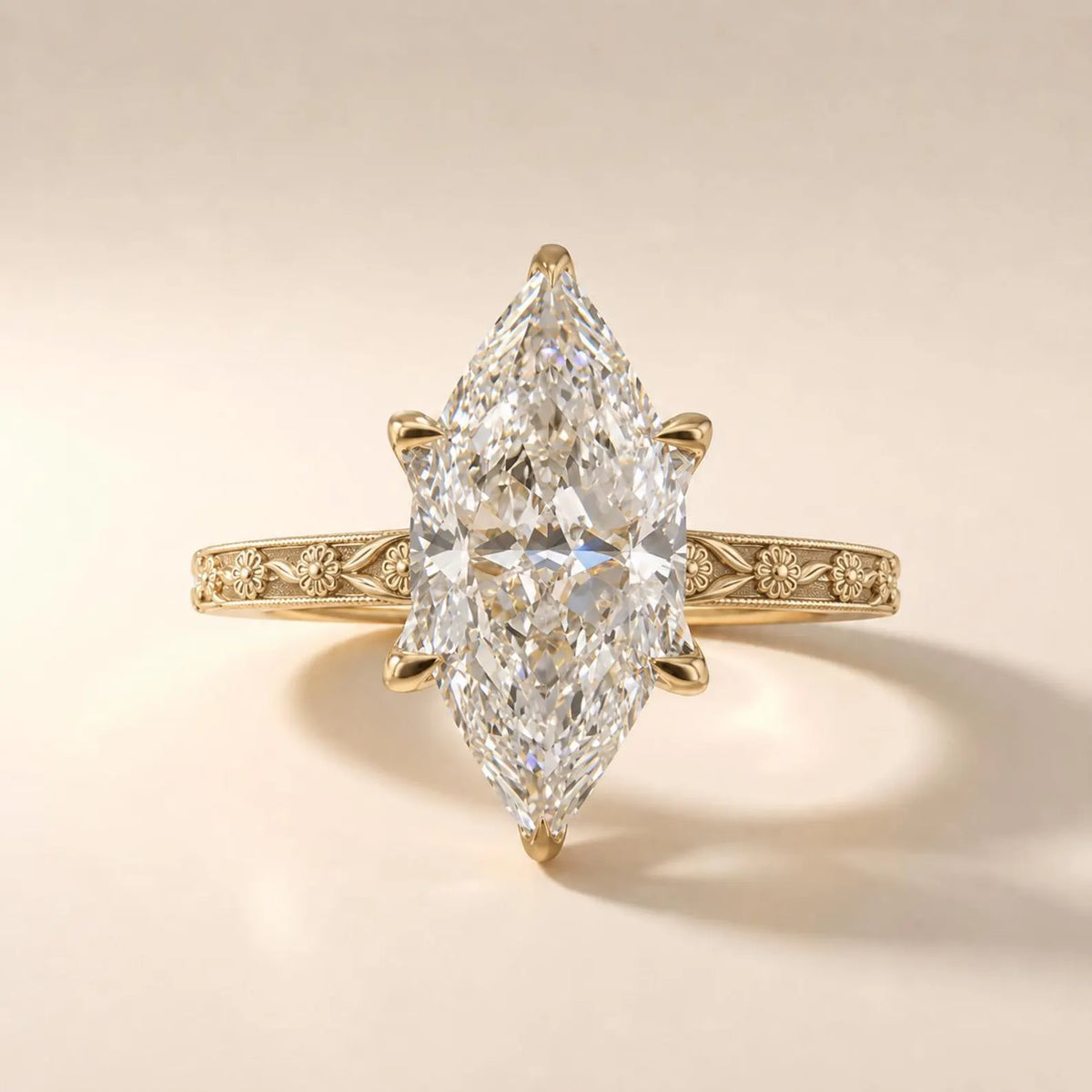 Top-down studio shot of a brilliant 3 CT marquise cut lab grown diamond solitaire ring with floral milgrain band.
