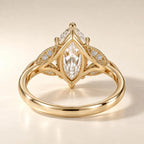Undergallery view displaying the openwork marquise setting and leaf accents on a yellow gold lab grown diamond ring.