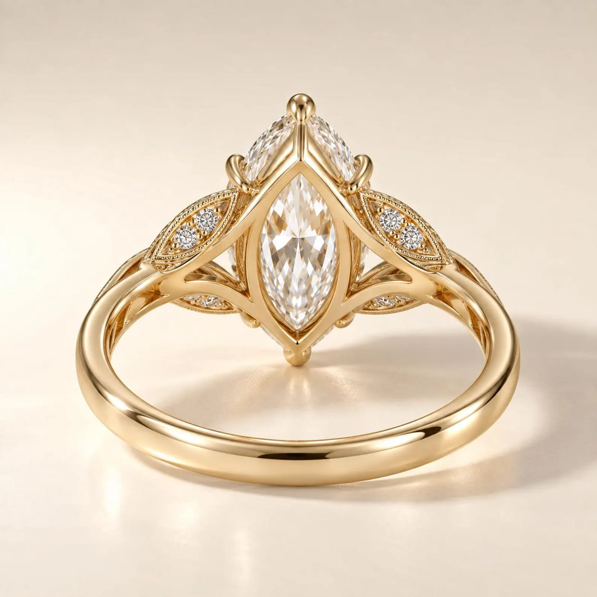Undergallery view displaying the openwork marquise setting and leaf accents on a yellow gold lab grown diamond ring.
