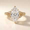 Front view showcasing a symmetrical 4 carat marquise lab diamond ring with leaf patterned side accents.