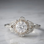 Studio shot of a 3 CT round cut lab grown diamond set in a white gold floral blooming petal halo setting.