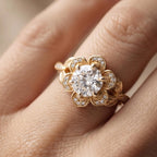 Close-up on hand showing the intricate diamond-paved flower petals of a 3 CT round lab diamond ring.
