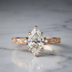 Studio shot on marble of a 3 CT marquise lab grown diamond ring in rose gold with vintage scrollwork band.