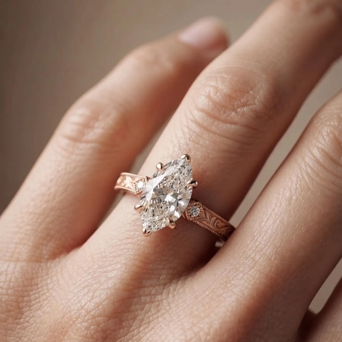 On-hand view in natural light highlighting a 3 CT marquise cut lab diamond in a vintage rose gold setting.