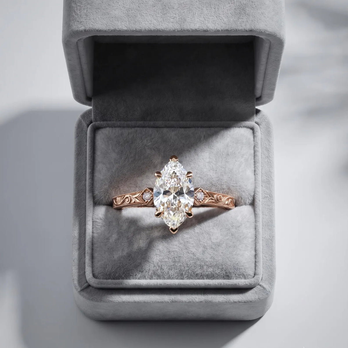3 CT marquise cut lab grown diamond ring displayed inside a grey velvet jewelry presentation box.