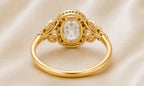 Underside gallery view of a yellow gold 3 CT oval lab diamond halo ring showing smooth comfortable inner band.