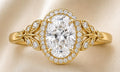 Direct top-down view of a 3 carat oval lab diamond ring with micro-pave halo and vintage leaf motif band.
