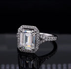 Top-down view of a 3 CT emerald cut lab grown diamond halo engagement ring with a split shank band.