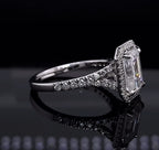 Side profile view showing the diamond-encrusted pavé split shank of a 3 carat emerald cut engagement ring.