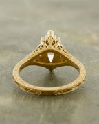 Detailed profile view of a yellow gold 4 CT marquise lab grown diamond ring showing heart filigree basket and engraved shank.