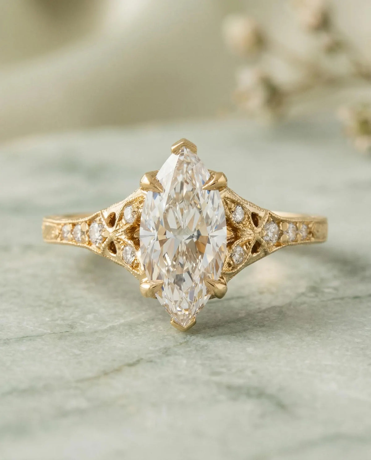 Top view of a 4 CT marquise cut lab grown diamond in a yellow gold vintage setting with micro-pave filigree shoulders.
