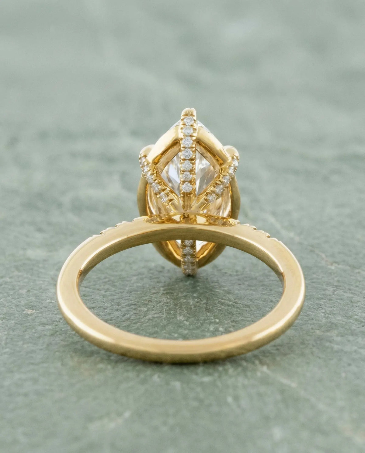 Under-gallery profile of yellow gold 4 CT marquise lab diamond ring showing pave diamond bridge support.