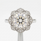 Top-down view of a 4 CT cushion cut lab diamond in a vintage geometric fan halo setting in white gold.