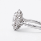 Profile view of a 4 CT cushion lab diamond ring in white gold showing the pierced filigree cathedral setting.
