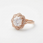 Three-quarter view of a 4 CT cushion cut lab diamond ring with milgrain fan halo in rose gold.