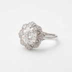 Angled perspective of a 4 CT cushion lab diamond ring in white gold with ornate diamond-paved fan halo.