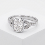 Angled view of a 3 CT radiant cut lab grown diamond ring with full bezel border in white gold.