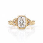 Overhead view of a 3 CT radiant cut lab grown diamond bezel setting on a hammered yellow gold band.