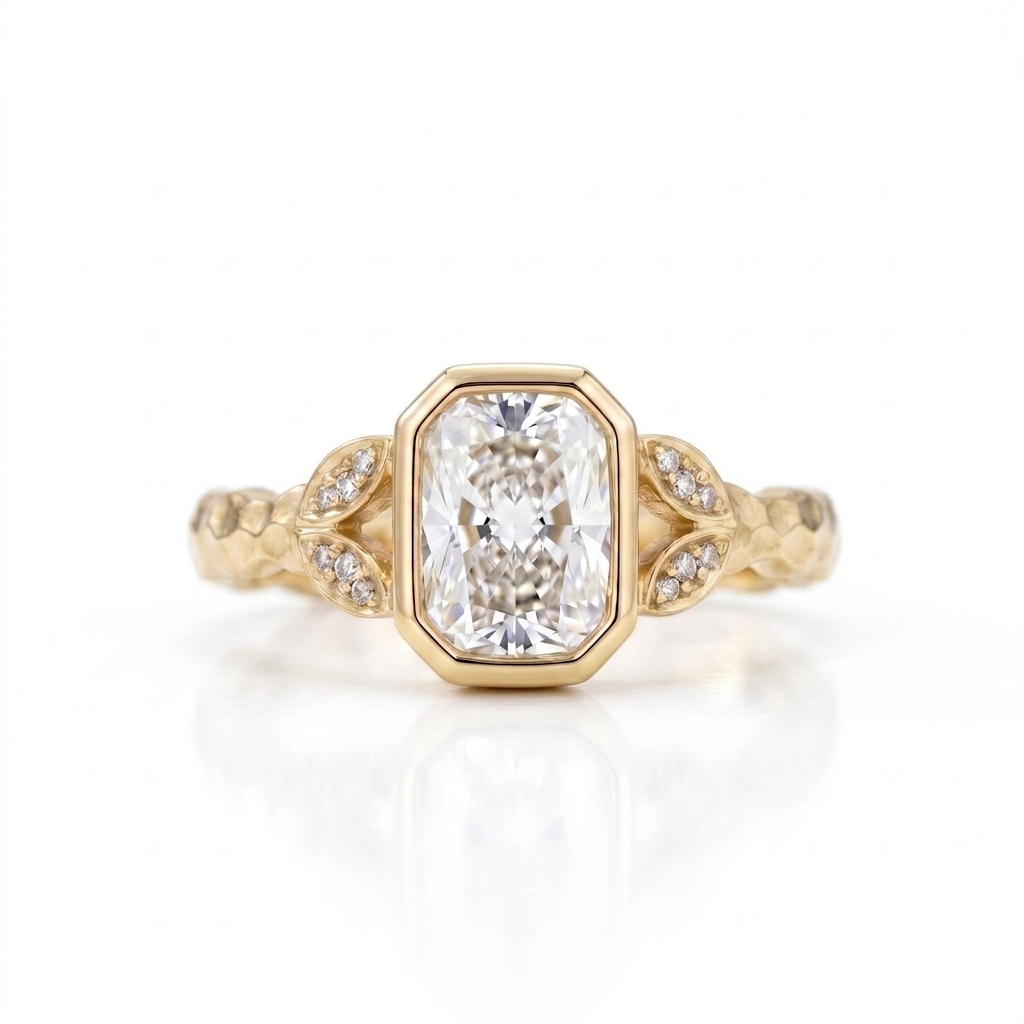 Overhead view of a 3 CT radiant cut lab grown diamond bezel setting on a hammered yellow gold band.