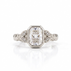 Top view of a 3 CT radiant cut lab grown diamond bezel ring in white gold with leaf shoulders.