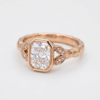 Angled perspective of a 3 CT radiant cut lab diamond bezel engagement ring in rose gold.