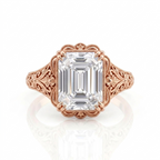 Direct top view of a 5 CT emerald cut lab grown diamond engagement ring in rose gold with vintage floral filigree shoulders.