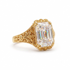 Angled perspective of a 5 CT emerald cut lab diamond vintage engagement ring crafted in yellow gold.