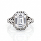 Top-down view of a 5 CT emerald cut lab grown diamond ring in white gold with scalloped milgrain bezel border.