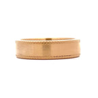 Front view of men's brushed gold wedding band featuring diamond-cut textured edges