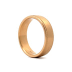 Angled side view highlighting the satin finish and cross-hatch pattern on men's gold band