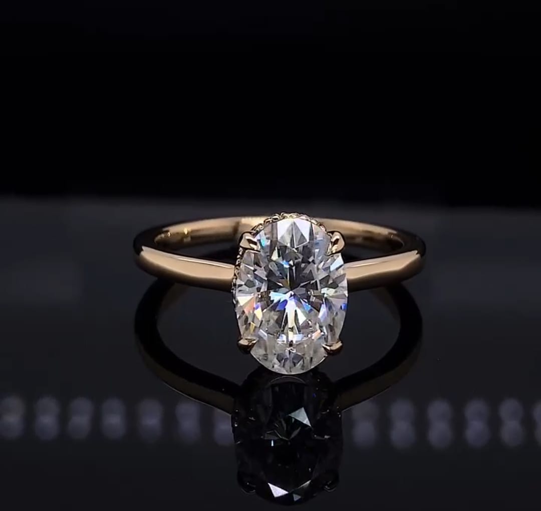 Direct top-down view of a 2 CT oval cut lab grown diamond engagement ring with a smooth gold band.